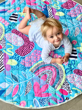 Load image into Gallery viewer, Toddler on blue patterned play mat
